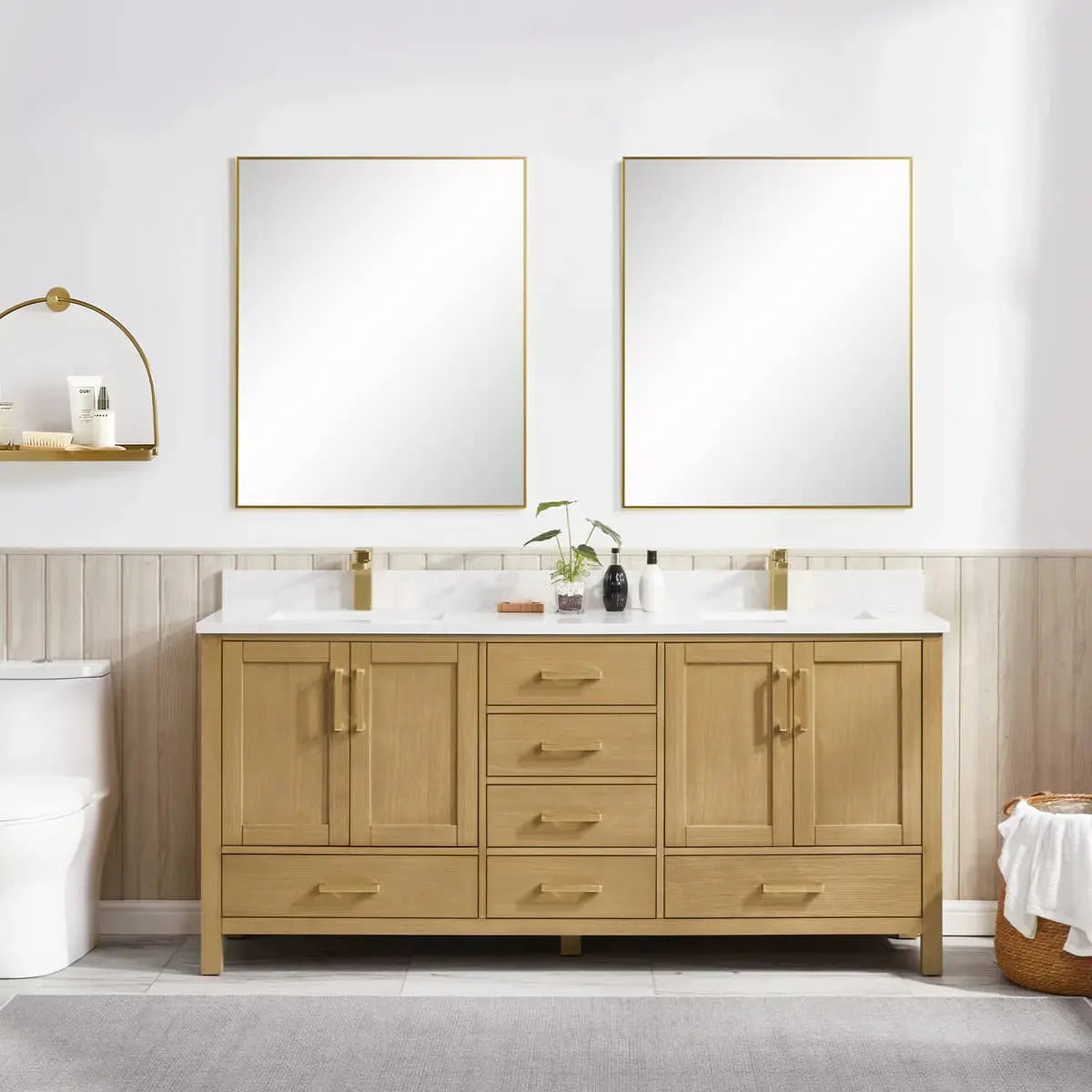 Bathroom vanity with wooden cabinets, white countertop, and two gold-framed mirrors.